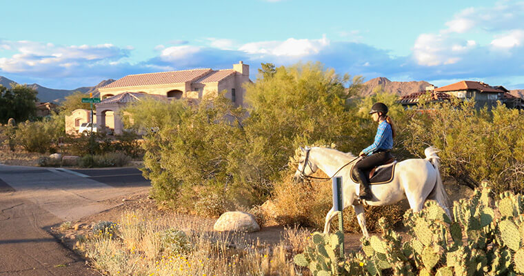 Woman riding a horse on the neighborhood trail system